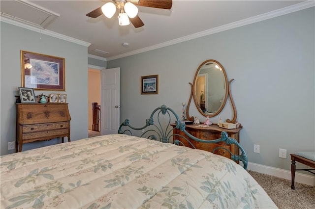 carpeted bedroom with crown molding, a ceiling fan, attic access, and baseboards