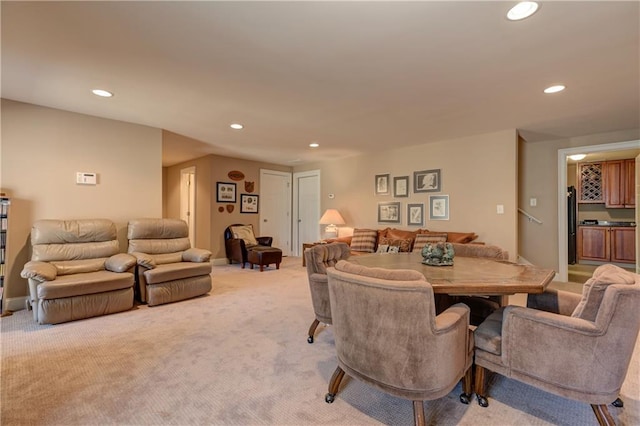 dining area with light carpet, baseboards, and recessed lighting