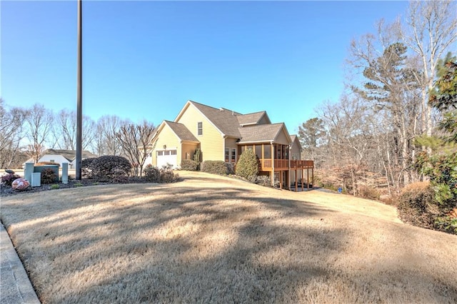 view of front of house featuring a wooden deck and a front lawn