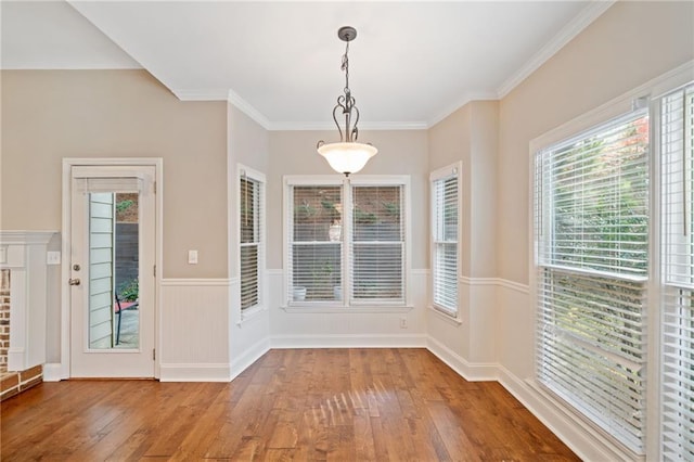 dining room with a fireplace, dark hardwood / wood-style floors, and ornamental molding