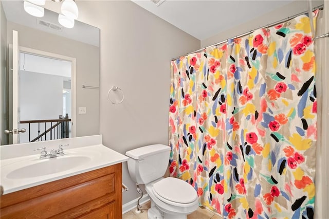 bathroom with tile patterned flooring, vanity, curtained shower, and toilet