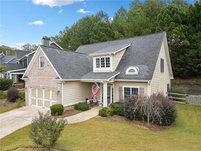 view of front of house featuring a garage and a front lawn