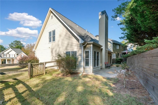 back of property with a lawn and a patio