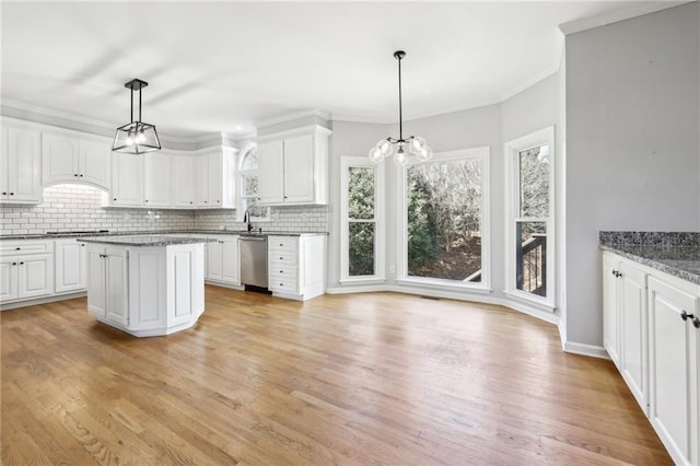 kitchen featuring ornamental molding, white cabinetry, dishwasher, and decorative backsplash