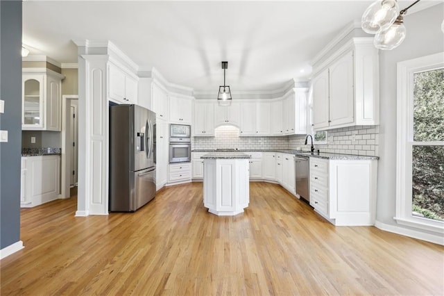 kitchen with white cabinets, backsplash, stainless steel appliances, and a sink