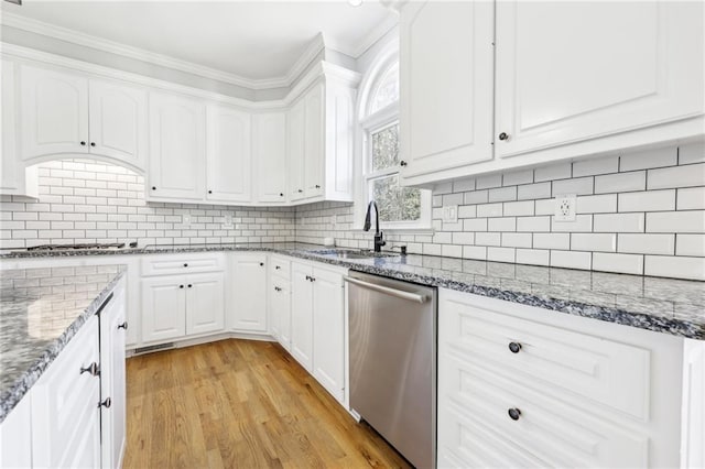 kitchen with a sink, tasteful backsplash, white cabinets, and dishwasher