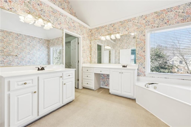 full bath featuring wallpapered walls, two vanities, vaulted ceiling, and a sink