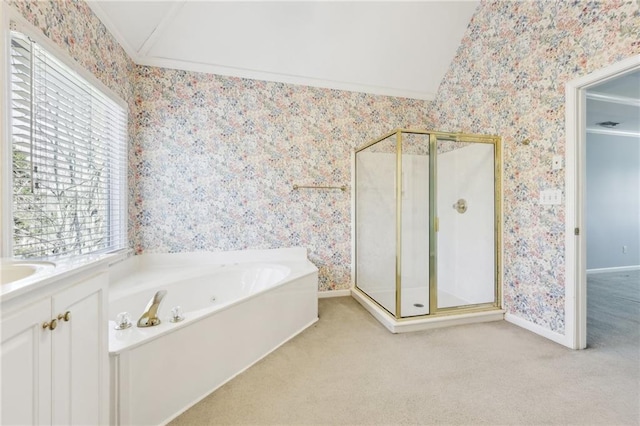 bathroom featuring lofted ceiling, wallpapered walls, a garden tub, and a stall shower