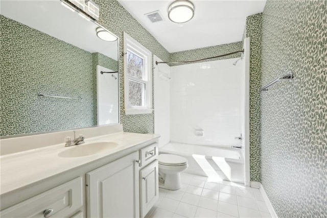 bathroom with wallpapered walls, toilet, tile patterned floors, vanity, and washtub / shower combination