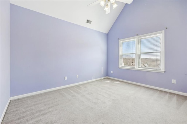 spare room featuring carpet floors, visible vents, ceiling fan, high vaulted ceiling, and baseboards