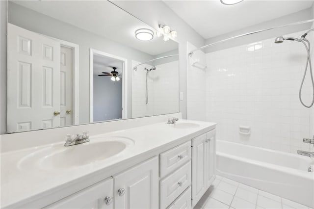 bathroom with double vanity, tub / shower combination, a sink, and tile patterned floors