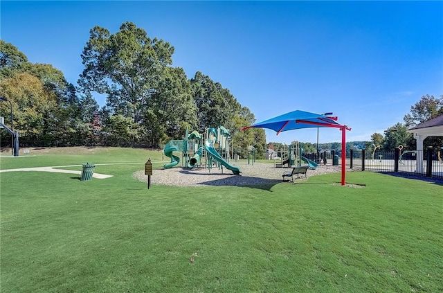 community playground with fence and a lawn