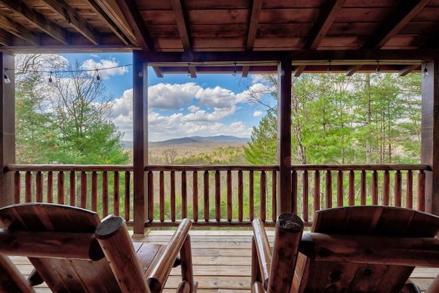 wooden deck with a mountain view