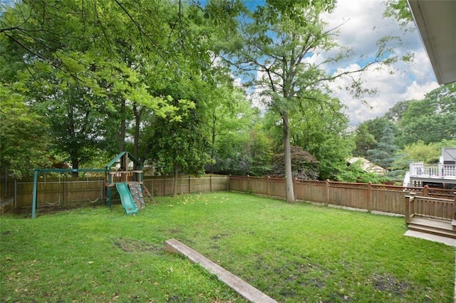 view of yard featuring a playground and a wooden deck