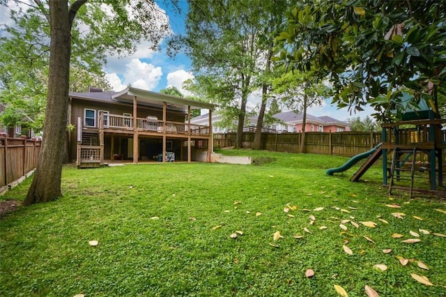 view of yard featuring a playground and a wooden deck