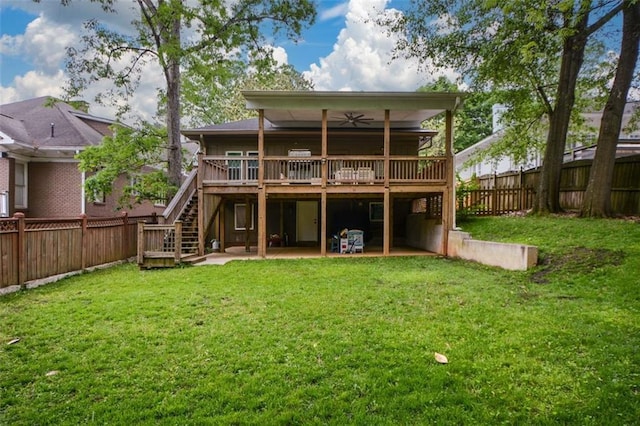 rear view of house with a deck, a patio, and a yard