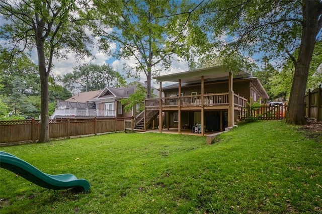 back of property with a wooden deck and a yard