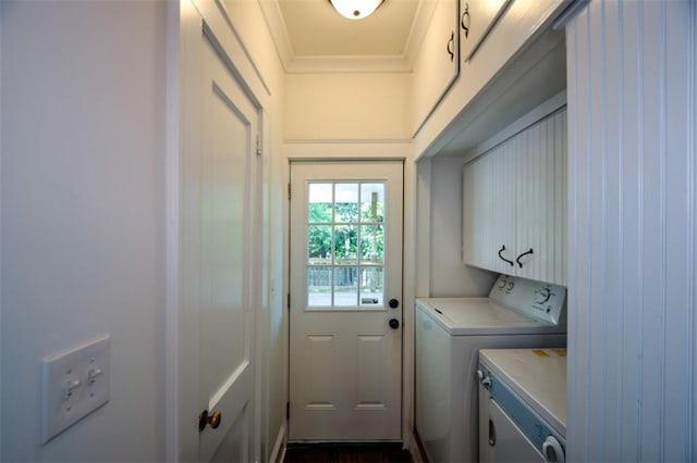 washroom featuring cabinets, washer and clothes dryer, and ornamental molding