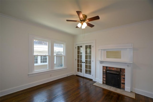 unfurnished living room featuring a fireplace, ceiling fan, french doors, ornamental molding, and dark wood-type flooring