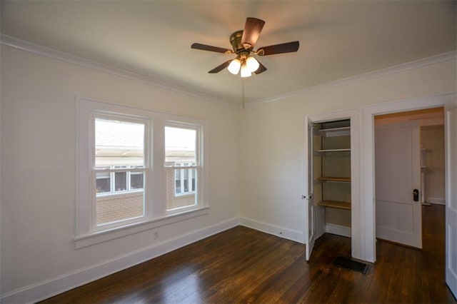 unfurnished bedroom featuring ornamental molding, dark hardwood / wood-style flooring, and ceiling fan