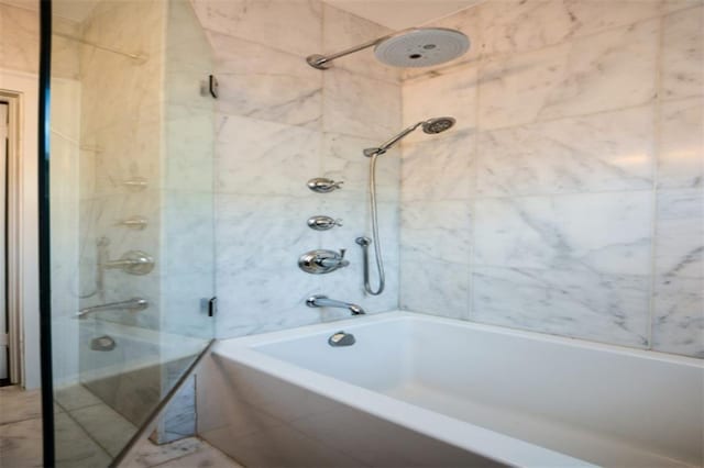 bathroom with tile flooring and tiled shower / bath combo