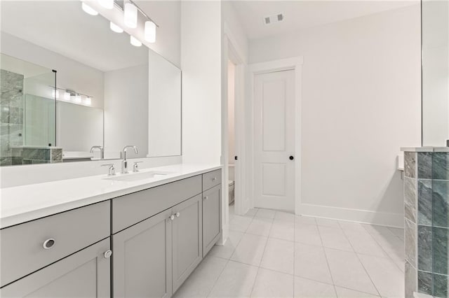 bathroom featuring vanity, tile patterned flooring, and toilet