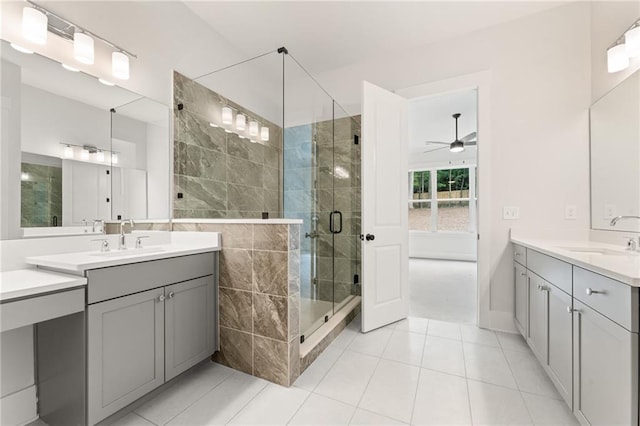 bathroom with a shower with door, ceiling fan, double sink vanity, and tile patterned flooring