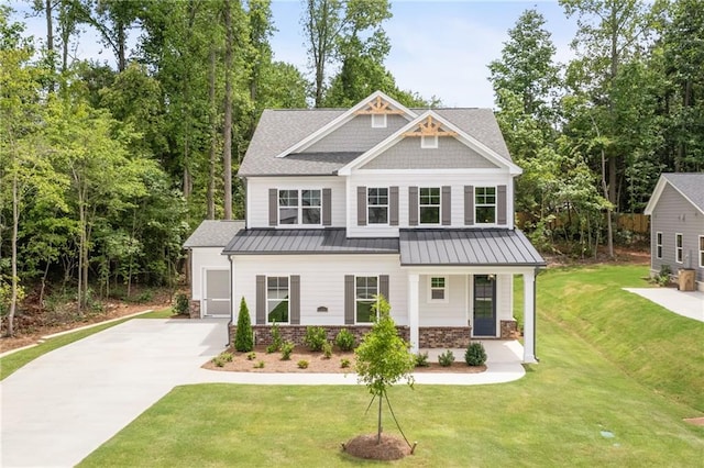 craftsman-style house featuring covered porch and a front yard