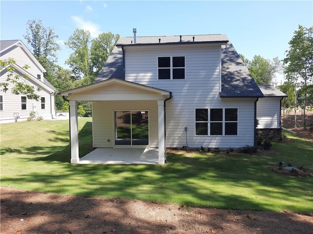 back of house featuring a patio and a yard