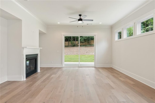 unfurnished living room featuring light hardwood / wood-style floors, ceiling fan, and crown molding