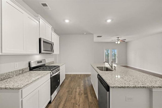 kitchen with white cabinetry, appliances with stainless steel finishes, sink, and a kitchen island with sink