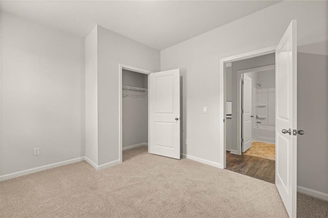 unfurnished bedroom featuring carpet and a closet