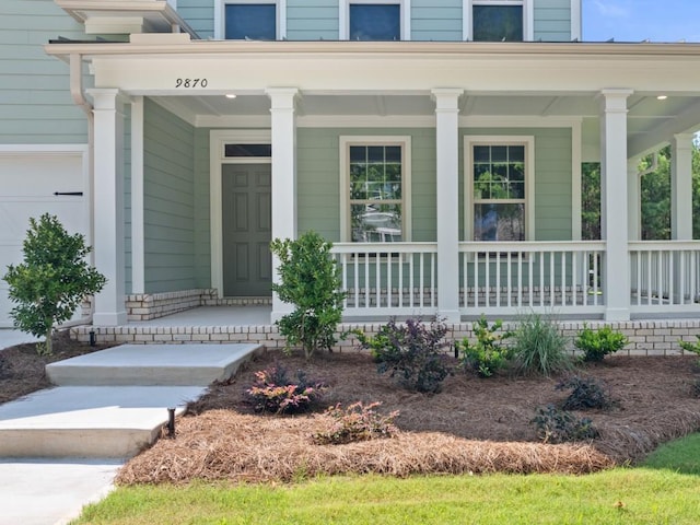 property entrance featuring a garage and a porch