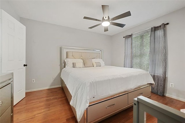 bedroom with baseboards, a ceiling fan, and wood finished floors