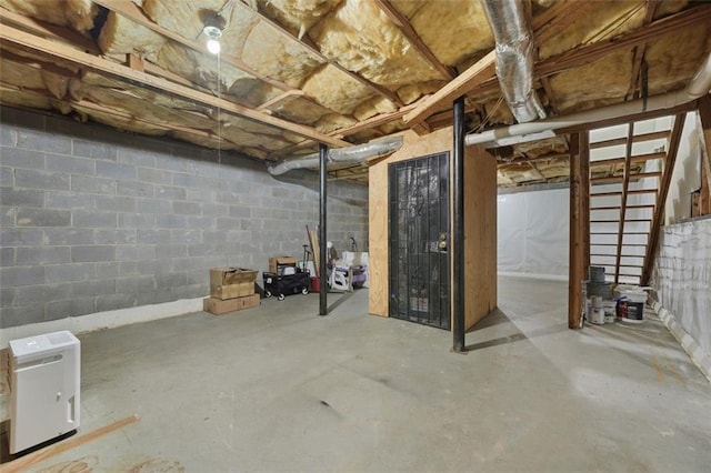 unfinished basement with concrete block wall