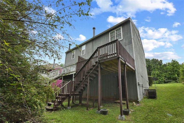 back of house featuring stairs, a lawn, central AC, and a deck