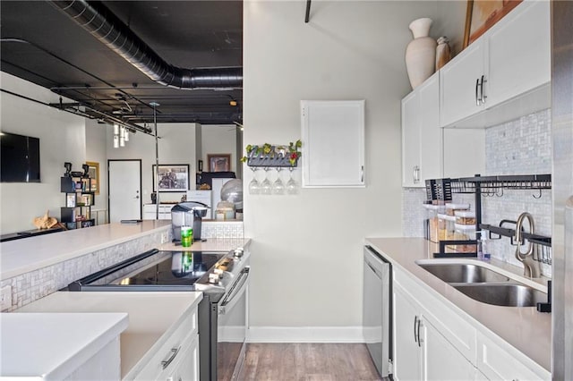 120 Ralph Mcgill Blvd NE Unit 1409, Atlanta, GA 30308 - kitchen featuring stainless steel appliances, wood finished floors, tasteful backsplash, light countertops, and white cabinets