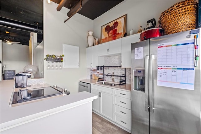 120 Ralph Mcgill Blvd NE Unit 1409, Atlanta, GA 30308 - kitchen with stainless steel appliances, backsplash, white cabinetry, light countertops, and light wood finished floors