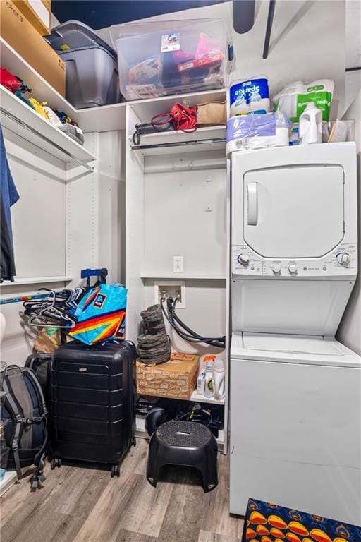 120 Ralph Mcgill Blvd NE Unit 1409, Atlanta, GA 30308 - laundry area with stacked washing machine and dryer and wood finished floors