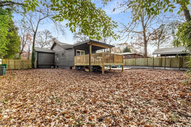 back of property featuring a wooden deck and a fenced backyard
