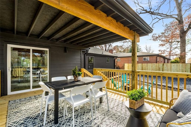 deck with outdoor dining area and fence