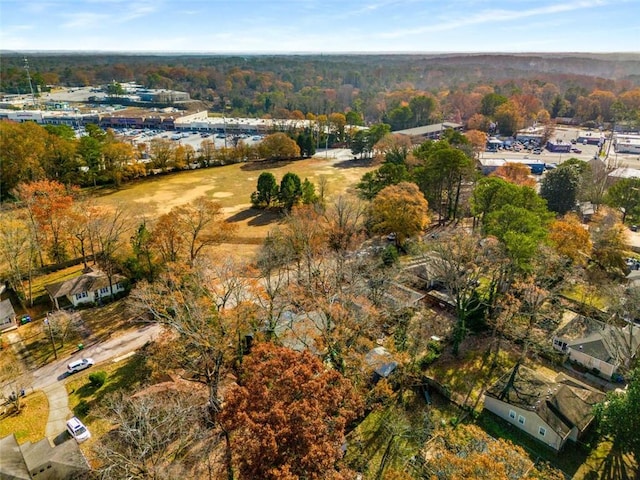 aerial view of property's location with a heavily wooded area