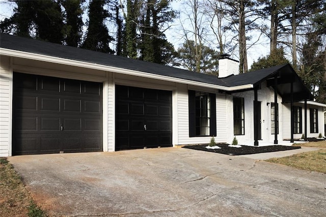 view of property exterior featuring driveway, a chimney, and a garage