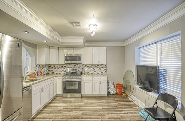 6414 Wedgewood Trce, Tucker, GA 30084 - kitchen featuring appliances with stainless steel finishes, backsplash, white cabinetry, and sink