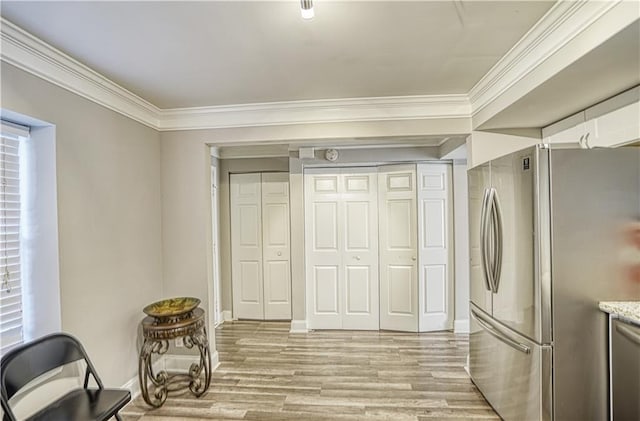 6414 Wedgewood Trce, Tucker, GA 30084 - kitchen featuring stainless steel fridge, light hardwood / wood-style floors, white cabinetry, and crown molding