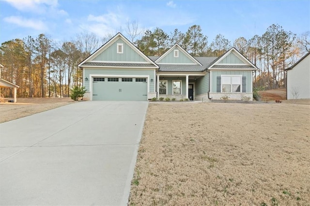 craftsman-style home with a garage, driveway, and board and batten siding