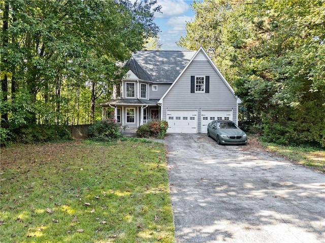 view of front facade featuring a front yard, a porch, and a garage