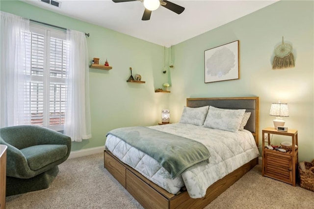 bedroom featuring carpet, multiple windows, baseboards, and a ceiling fan