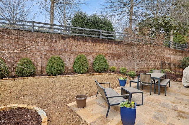 view of patio / terrace featuring outdoor dining area and fence