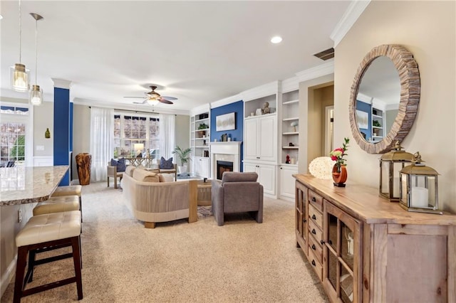 living room with crown molding, a fireplace, a wealth of natural light, and light colored carpet